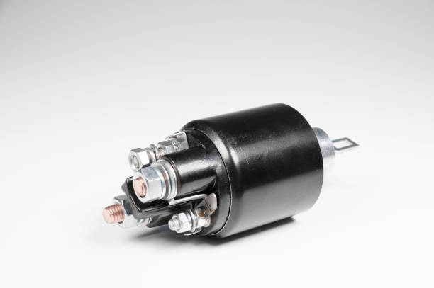 istock New black solenoid for a starter for a car on a gray gradient background. Auto parts. Starter Parts 1198388391
