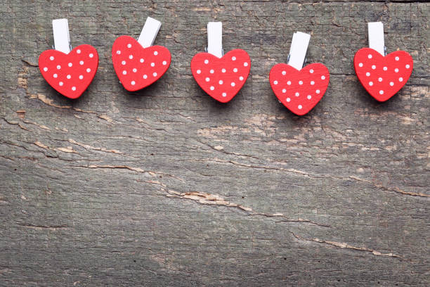 istock Clothespins with red hearts on gray wooden table 1198392230