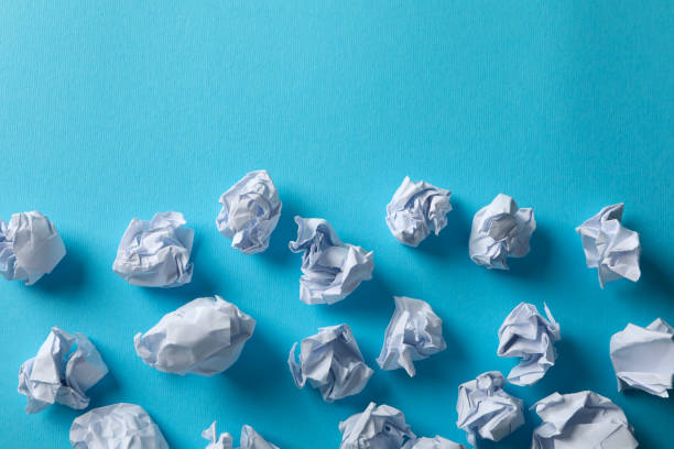 istock Paper balls on blue background, space for text 1198392398