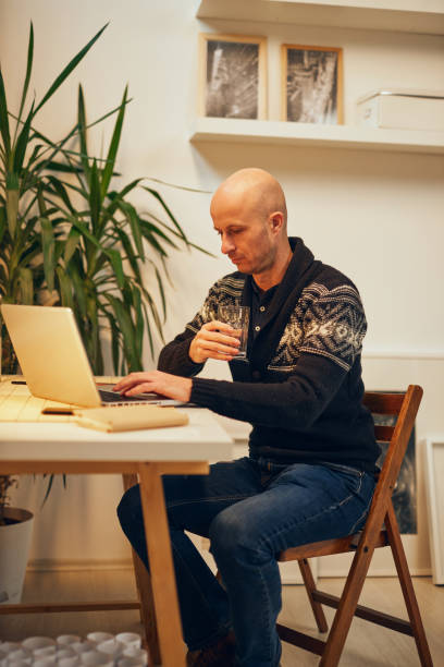 istock Young attractive Caucasian freelancer sitting at his home office and working. 1198393623