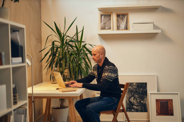 istock Young attractive Caucasian freelancer sitting at his home office and working. 1198393690