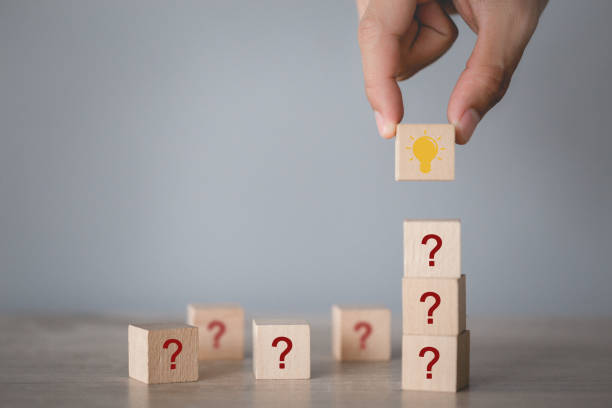 istock Hand arranging wood block stacking with icon question mark and lamp,thinking with question mark concept. 1198396260