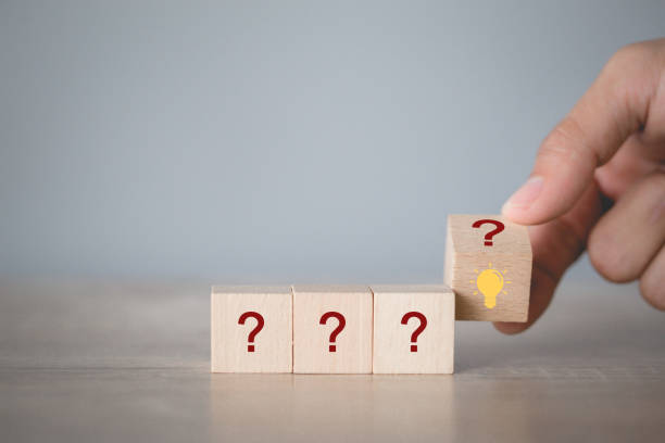 istock Hand arranging flips wood block stacking with icon question mark and lamp,thinking with question mark concept. 1198396276