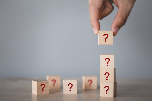 istock Hand arranging wood block stacking with icon question mark,thinking with question mark concept. 1198396277