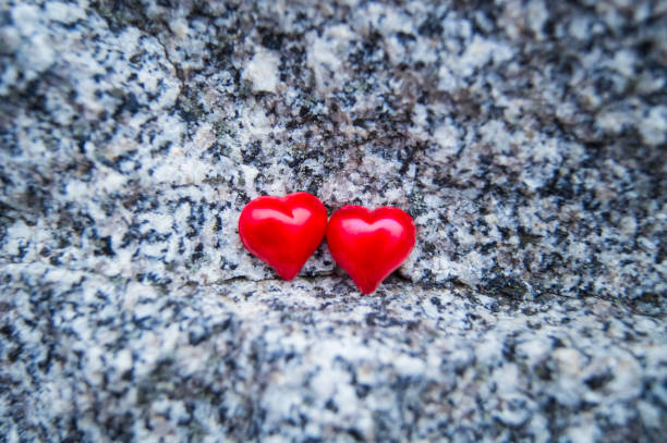 two red hearts on a beautiful stone background