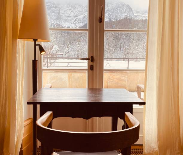 istock Old wooden table at the window 1198397485