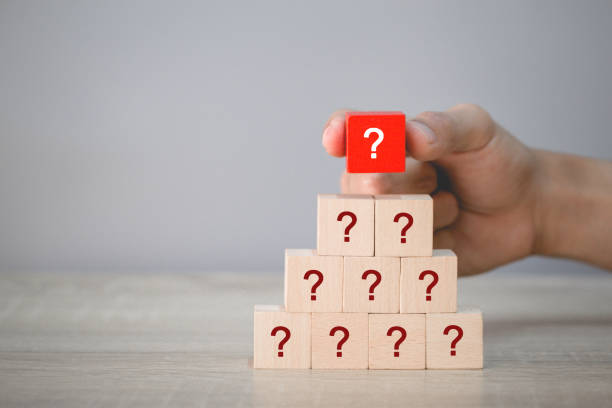 istock Hand arranging wood block stacking with icon question mark,thinking with question mark concept. 1198397855