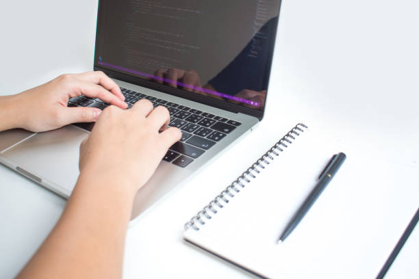 istock The hands of programmers using laptop isolated on white background. 1198398790