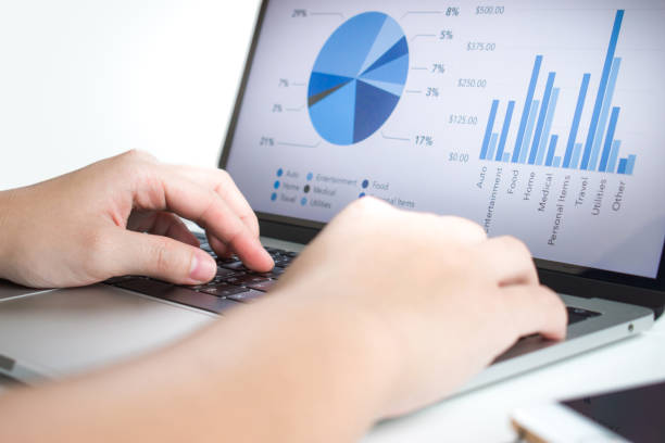 istock Businessmen use laptops to analyze statistics. Look at the presentation screen with graphs and financial report diagrams. 1198398829
