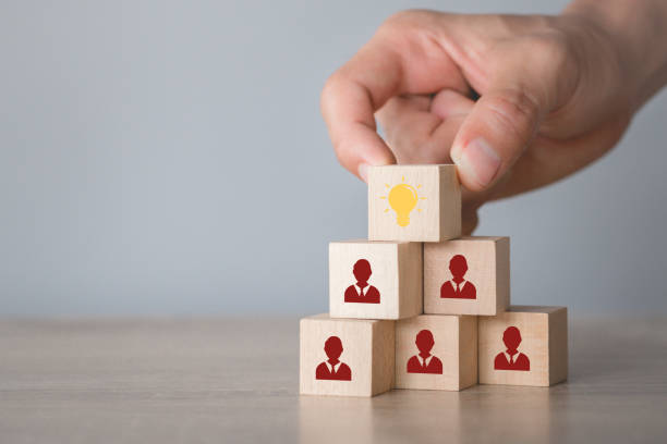 istock Hand choosing wood cube with icon light bulb and human symbol,creative idea and innovation concept. 1198399936