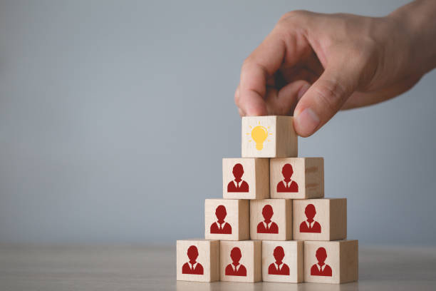 istock Hand choosing wood cube with icon light bulb and human symbol,creative idea and innovation concept. 1198400040
