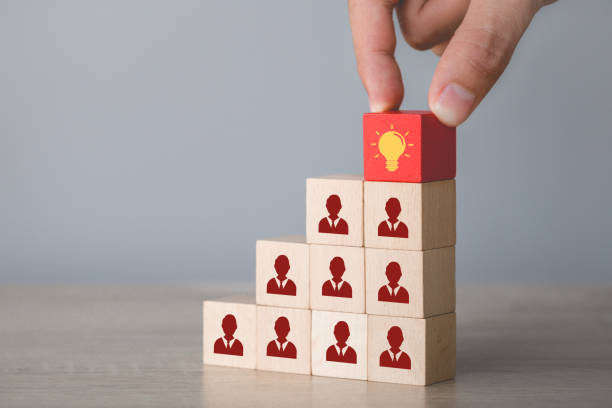 istock Hand choosing wood cube with icon light bulb and human symbol,creative idea and innovation concept. 1198400328