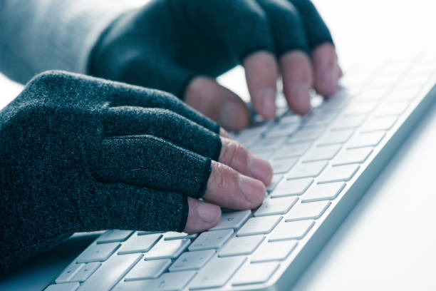 man wearing compression gloves stock photo