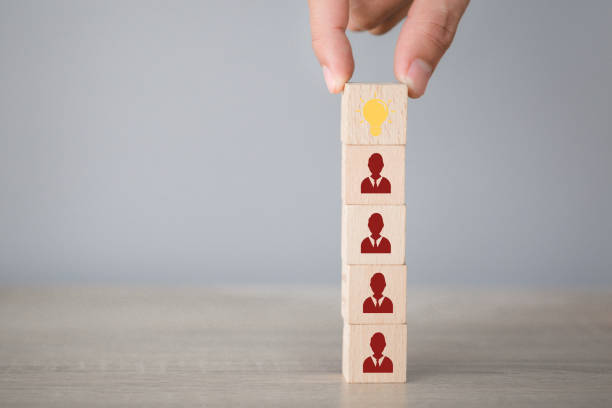 istock Hand choosing wood cube with icon light bulb and human symbol,creative idea and innovation concept. 1198400546