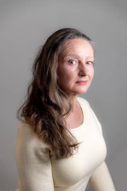istock Woman in yellow top on grey background 1198401327
