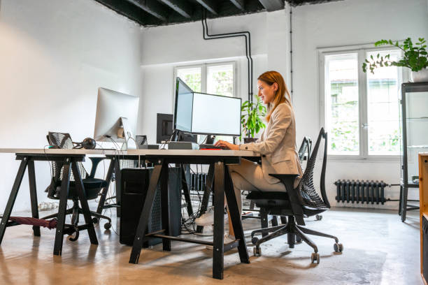 istock Young beautiful woman working in her office 1198401418