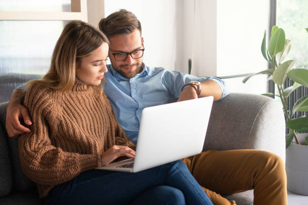 istock Young couple ordering online, looking in laptop 1198401568