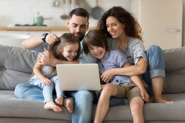 family with kids spend time together using laptop websites - mãe filho conversa imagens e fotografias de stock