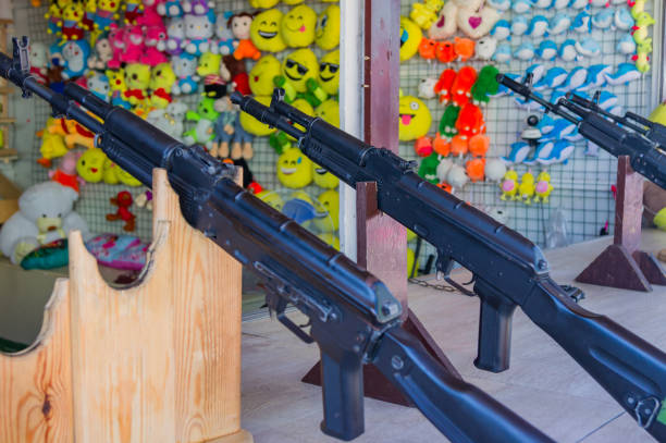 istock shooting gallery at the fair. Black rifles  for target shooting 1198401900