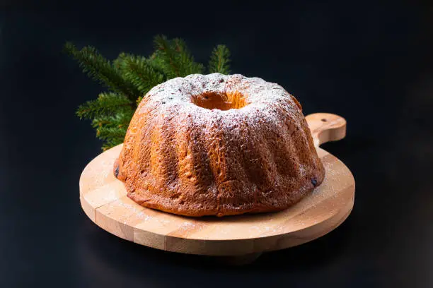 Photo of Food Concept homemade Gugelhupf, Guglhupf, Kugelhopf, kouglof bundt yeast cake of Central Europe on black background
