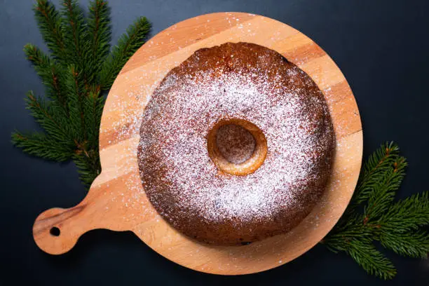 Food Concept homemade Gugelhupf, Guglhupf, Kugelhopf, kouglof bundt yeast cake of Central Europe on black background