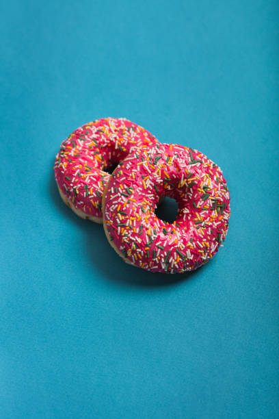 istock A cup of americano with two pink donuts on a blue background 1198405988