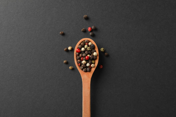 istock Wooden spoon with pepper spice on black background, top view 1198407218