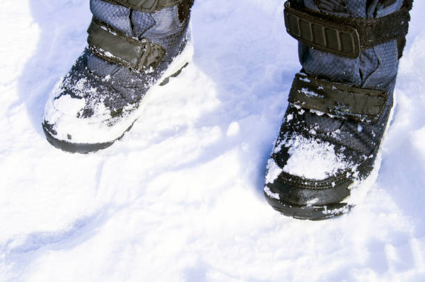 children's winter boots on white snow
