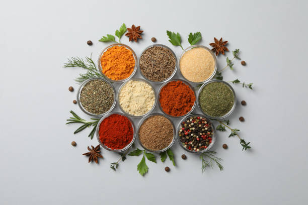 istock Glass bowls with different spices on white background, top view 1198407450