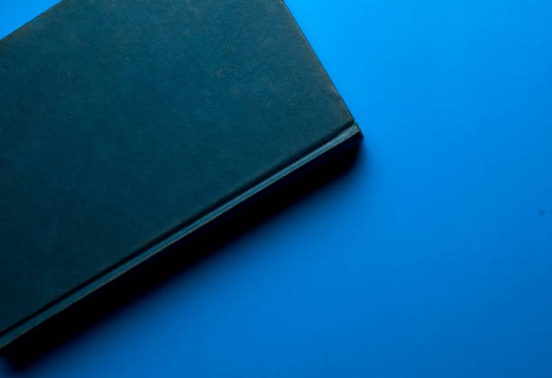 istock old book blue color, on blue background classic 1198408073