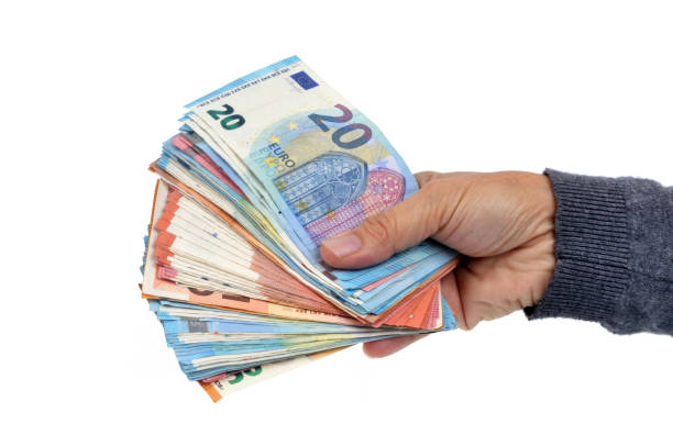 Bundle of banknotes in hand close-up hand holding euro banknotes on a white background european union photos stock pictures, royalty-free photos & images