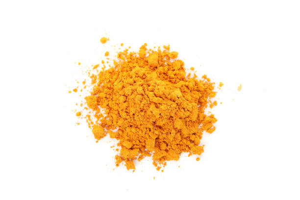 istock Fragrant turmeric powder heap isolated on white background 1198409341