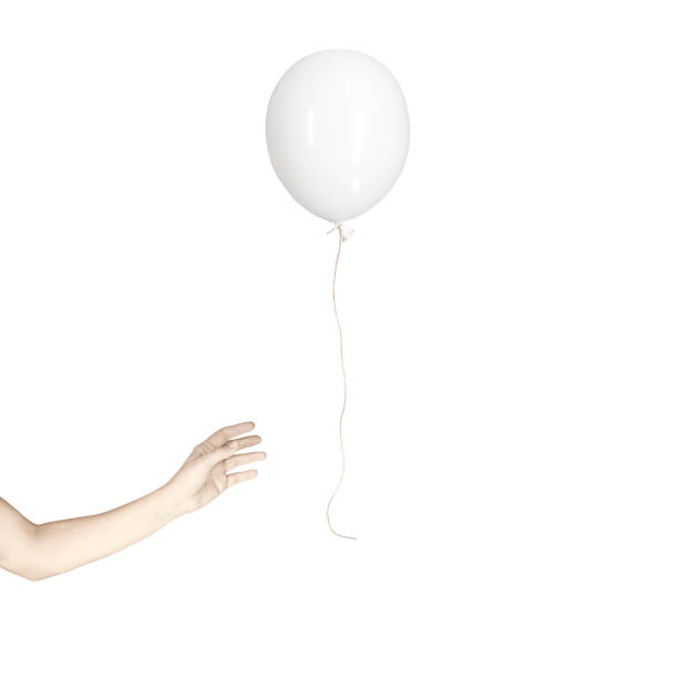istock hand tries to catch a balloon that runs away free 1198409367