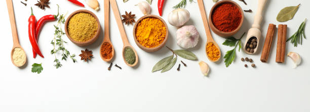 istock Spoons and bowls with different spices and ingredients on white background, space for text 1198409911