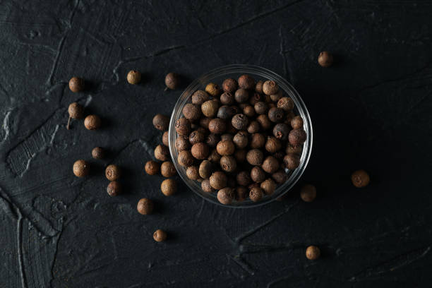 istock Bowl with peppercorns on black background, top view 1198409934