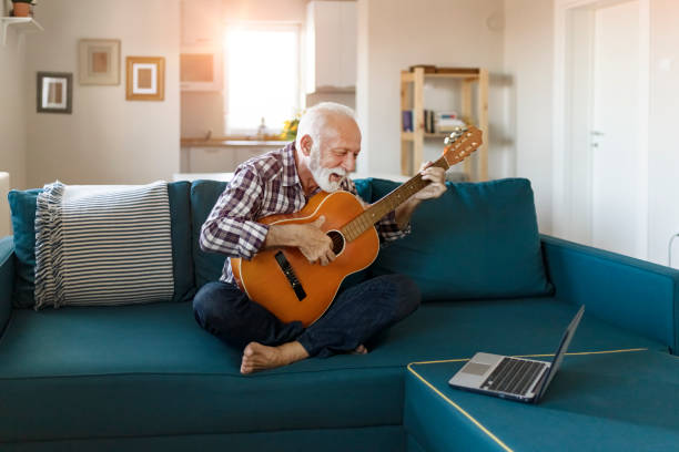 istock Senior Man Play Acoustic Guitar 1198410662