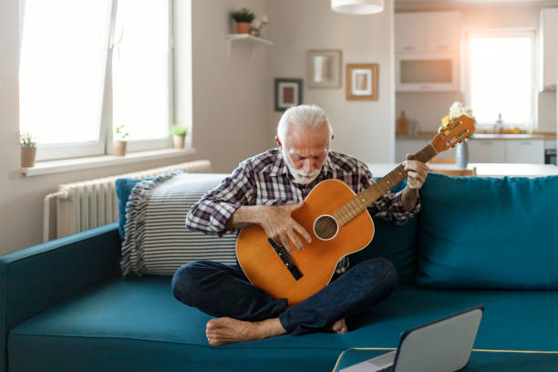 istock Senior Man Play Acoustic Guitar 1198410712