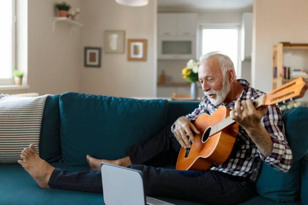 istock Senior Man Play Acoustic Guitar 1198410952
