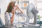 Woman suffers from heat in the office or at home