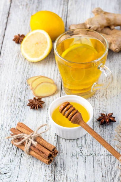 istock Autumn hot drink tea with ginger, lemon, honey and spices on white wooden background 1198414607