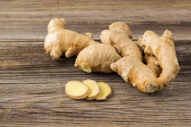 istock A root of ginger with sliced pieces on a wooden background 1198414614