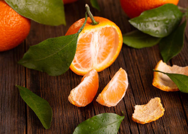 istock Tangerines on a wooden table top view. 1198415228