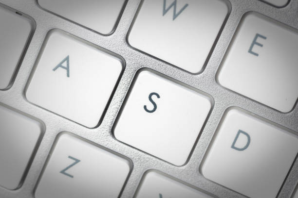 istock Computer keyboard - silver keyboard of a laptop with button S isolated. Home office with portable modern technology, IT and computing. 1198416016