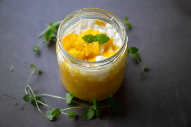 Sweet tapioca pudding with coconut milk, fresh mango and mint