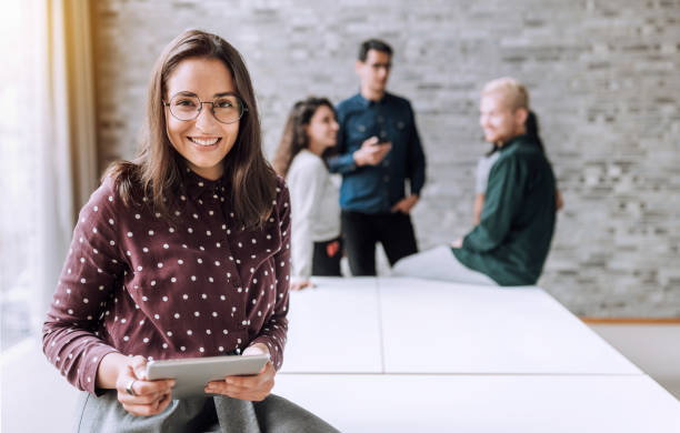 istock Smiling woman with a table t in office 1198416131