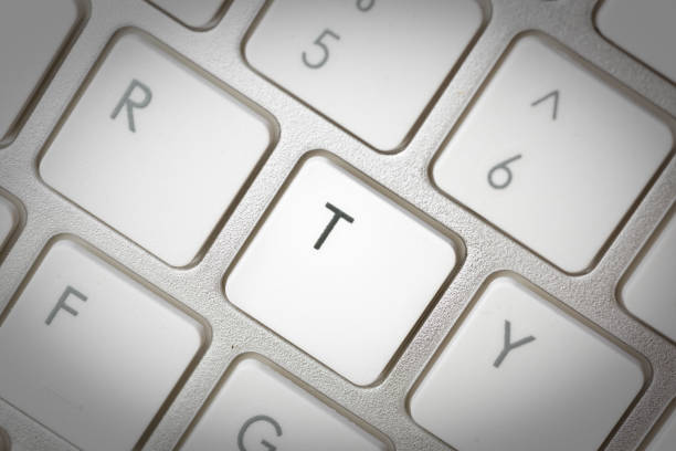 istock Computer keyboard - silver keyboard of a laptop with button T isolated. Home office with portable modern technology, IT and computing. 1198416395
