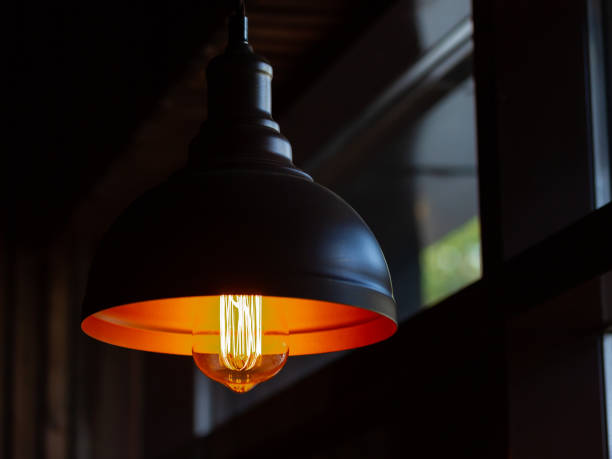 istock Light in a dark room, metal lampshade 1198416423