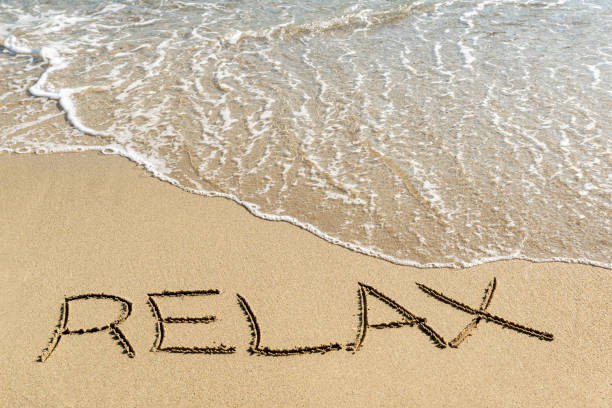 istock relax handwritten word at beach 1198416686