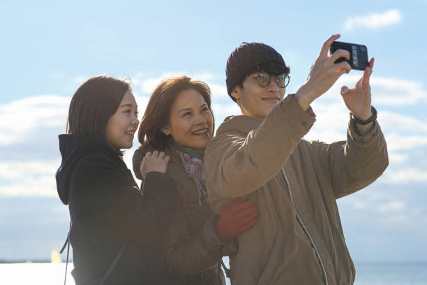 istock Happy family taking selfie on beach 1198417542