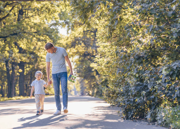 istock Happy father and son in summer park 1198417552